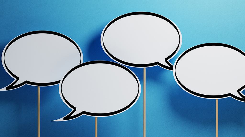 Four blank speech bubbles on sticks are displayed against a light blue background. The speech bubbles are white with black outlines, and they are positioned at different heights. The overall image suggests conversations or communication.