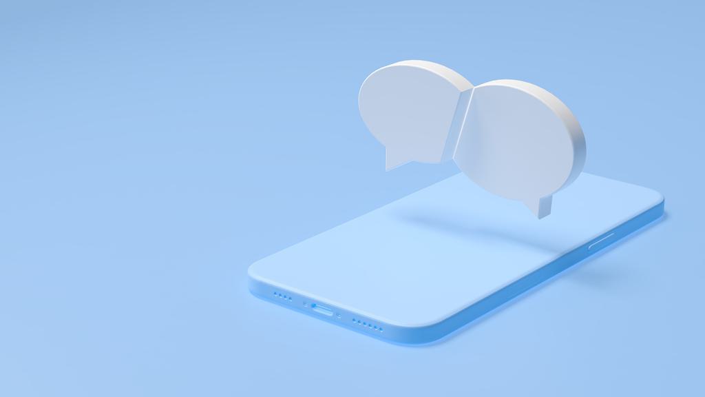 A 3D illustration of a smartphone lying on a blue surface with two large speech bubbles hovering above it, symbolizing messaging or online communication. The background is a solid light blue.