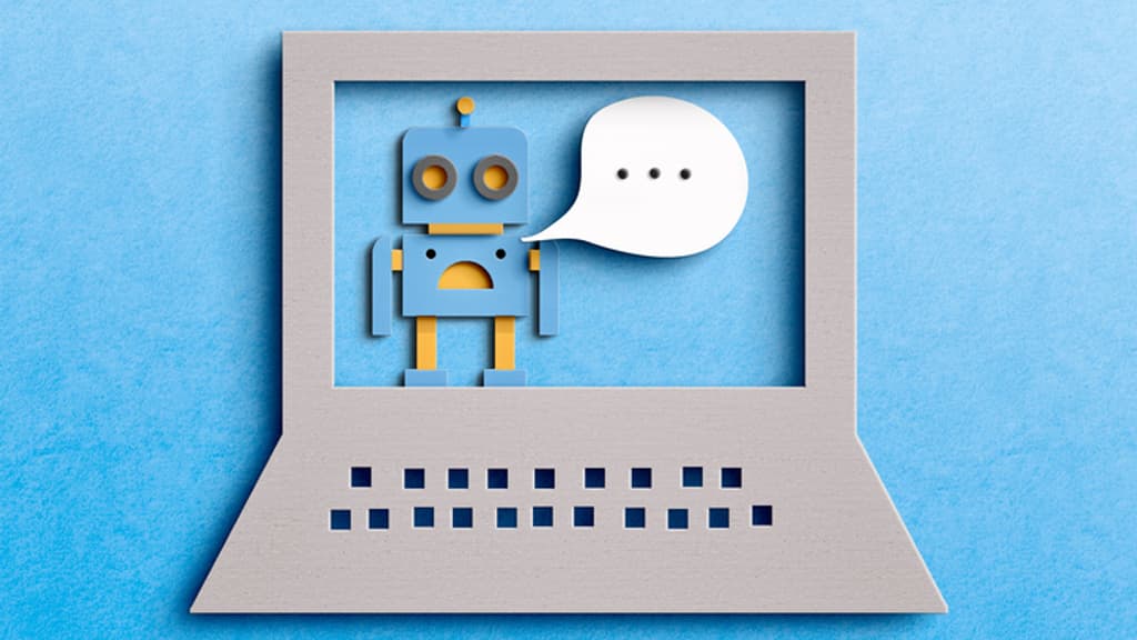 A paper-cut illustration of a robot with a speech bubble appears on a laptop screen against a blue background, symbolizing artificial intelligence or chatbot communication.