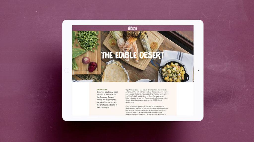 A tablet displaying a website with an article titled "The Edible Desert." The page features images of various foods, including grains, nuts, bread, and a bowl of mixed ingredients. The background is a maroon surface.